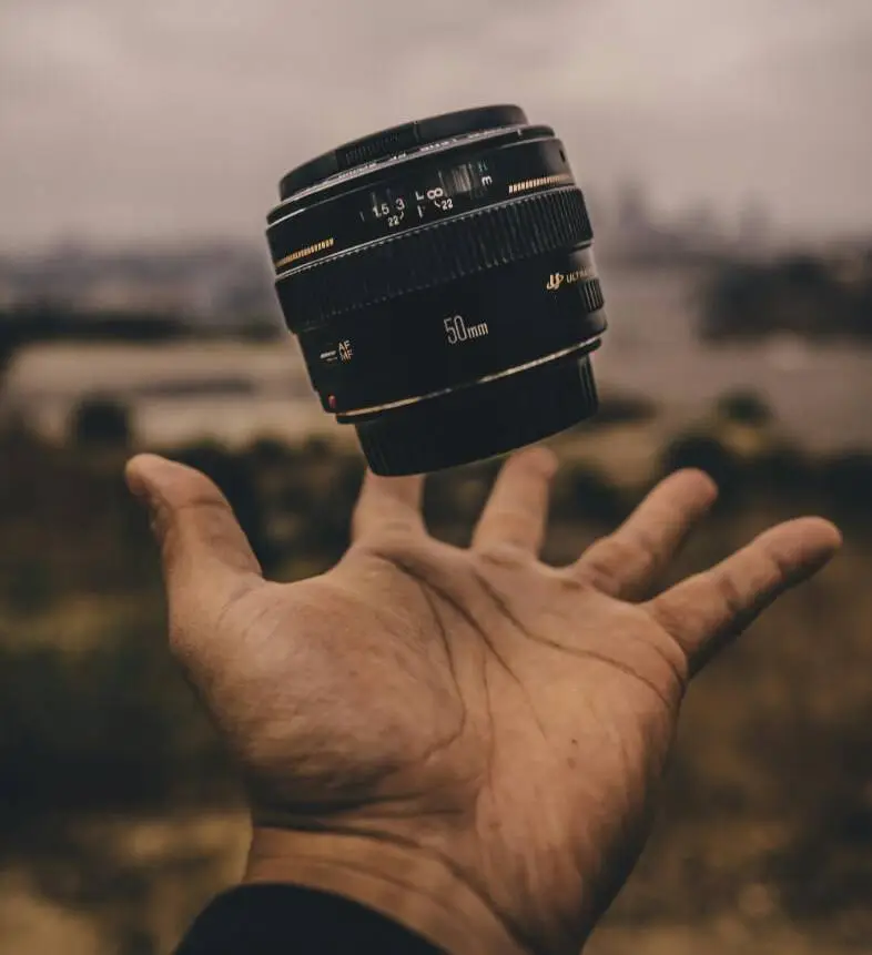 a person holding a lens